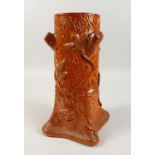 BROMPTON POTTERY, a salt glazed stick stand moulded as a tree stump. 36cms high.