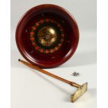 A TABLE TOP ROULETTE WHEEL, with accessories. 26cms diameter.