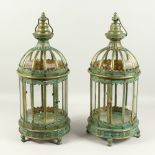 A PAIR OF DECORATIVE LANTERNS, with green and gilt patination. 60cms high.