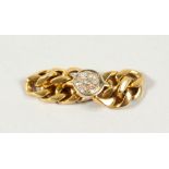 AN 18CT GOLD AND DIAMOND FINGER RING.