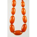 A BUTTERSCOTCH AMBER BEAD NECKLACE, comprising twenty beads. Largest: 25mm long. Overall Length: