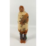 A RESERVATION INDIAN DOLL, painted plaster head. 43cms high.