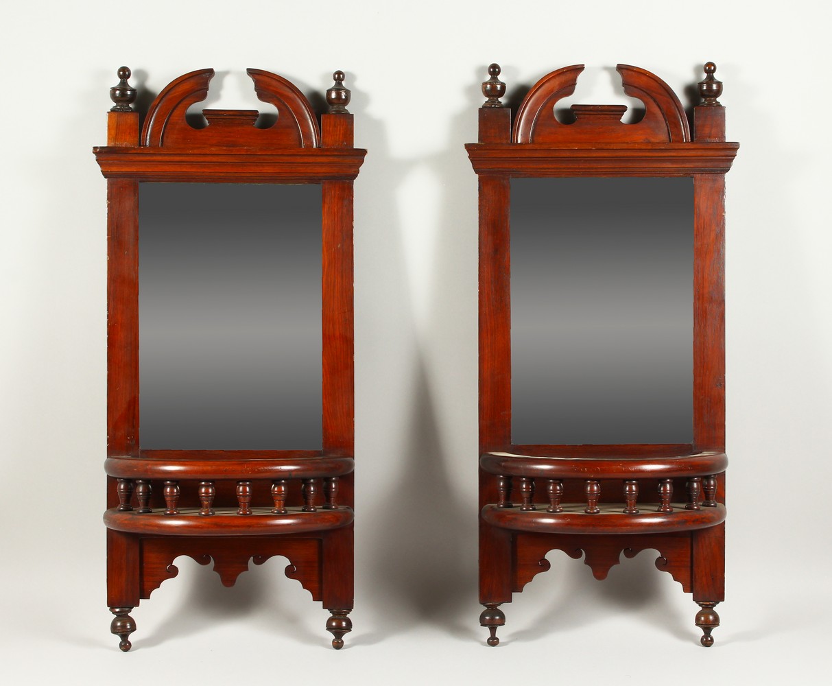 A PAIR OF LATE VICTORIAN WALNUT HALL MIRRORS. 72cms high x 33cms wide.