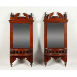 A PAIR OF LATE VICTORIAN WALNUT HALL MIRRORS. 72cms high x 33cms wide.