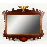 A GEORGIAN STYLE MAHOGANY FRETWORK FRAMED MIRROR, with shell inlay and eagle finial. 80cms high x