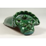 A GREEN GLAZED POTTERY ROOF TILE. 26cms long.