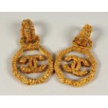 A PAIR OF GILT METAL CHANEL LOGO DROP EARRINGS. 4cms wide.