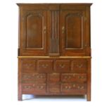 A 19TH CENTURY OAK HOUSEKEEPERS CUPBOARD, with a moulded cornice, central narrow "secret" door