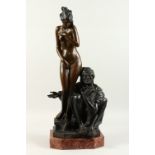 A GOOD LARGE BRONZE GROUP, of an Arab man seated by a standing female nude, on a marble base.