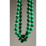 A GOOD STRING OF MALACHITE BEADS. 2ft 8ins long.
