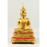 A LARGE GILT BRONZE THAI BUDDHA, in a seated position, on a lotus base. 54cms high.