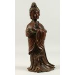 A BRONZE OF A STANDING LADY, holding a fan. 36cms high.