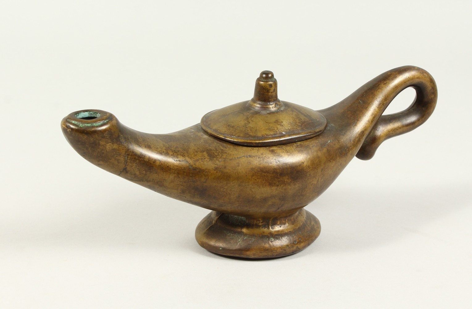 A BRONZE "ALADDINS LAMP" JUG. 28cms long.