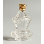 A GOLD TOP CUT GLASS SCENT BOTTLE. 9.5cms high.