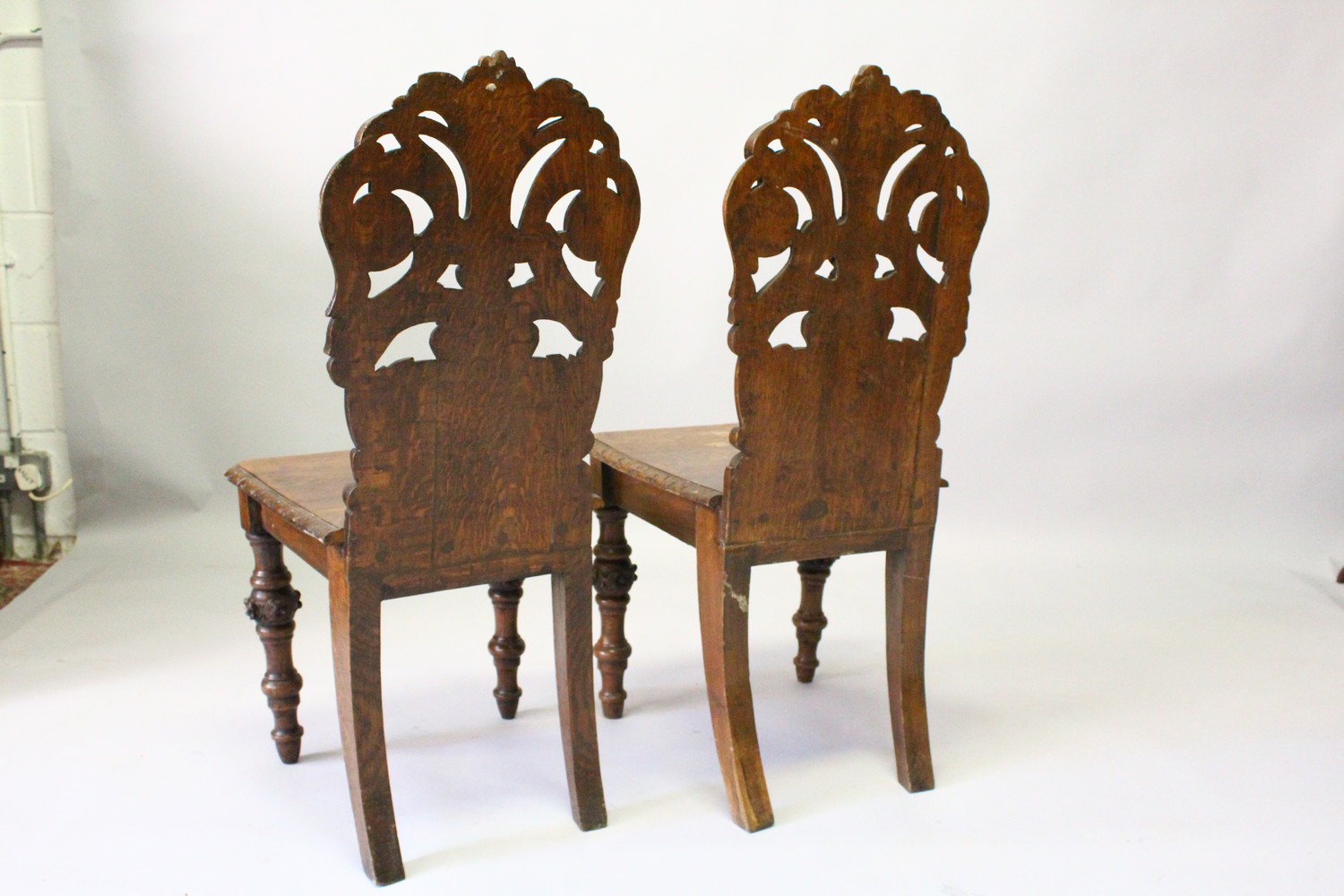 A PAIR OF VICTORIAN OAK HALL CHAIRS, with carved backs, solid seats, on turned and carved legs. - Image 5 of 6