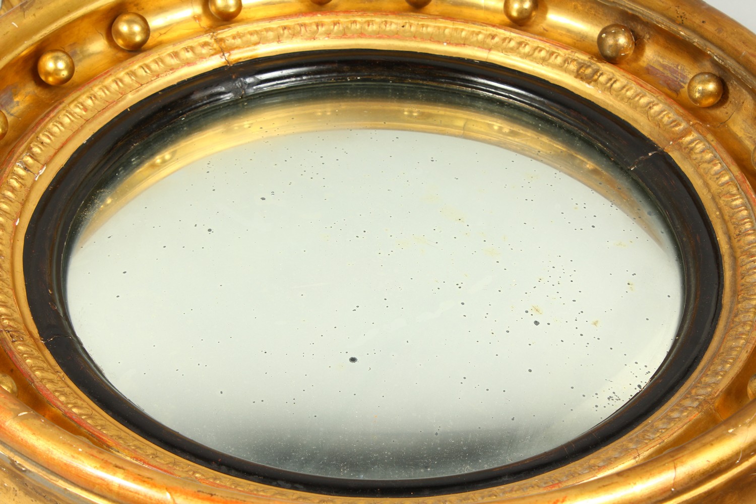 A REGENCY GILTWOOD CONVEX WALL MIRROR, with eagle cresting, ball applied frame, and leaf carved - Image 2 of 13