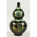 A FAMILLE NOIR PORCELAIN VASE, painted with exotic birds and symbols. 24cms high.