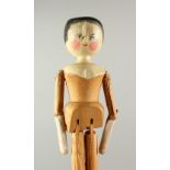 A CARVED PINE FOLK ART DOLL. 29cms high.