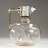A PLAIN GLASS VICTORIAN CLARET JUG, with silver mounts. London 1898.