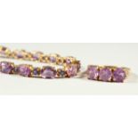A 9CT GOLD AMETHYST BRACELET AND THREE STONE RING.