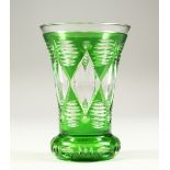 A BOHEMIAN GREEN TINTED THISTLE SHAPED BEAKER-VASE on a plain base. 5.25ins high.