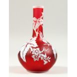 A SUPERB RED AND WHITE CAMEO GLASS BOTTLE VASE, with leaves and flowers. 7ins high x 4ins diameter.