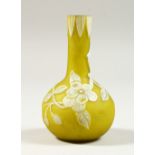 A MINIATURE YELLOW AND WHITE BOTTLE VASE, with leaves and flowers. 3.5ins high.