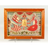 A WWI WOOLWORK PICTURE, with a photograph of a young man surrounded by flags of the nations. 53cms