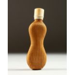 AN ART DECO BABY SHAPED SCENT BOTTLE with screw ivory cap. 8cms long