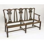 A CHIPPENDALE STYLE MAHOGANY THREE SEATER CHAIR BACK SETTEE, with carved cresting rail, pierced