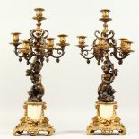 A PAIR OF 20TH CENTURY BRONZE, ORMOLU AND MARBLE FIVE BRANCH, SIX-LIGHT CANDELABRA, with cherub