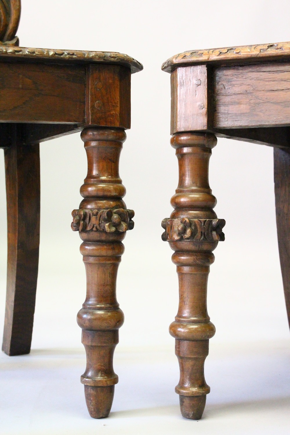 A PAIR OF VICTORIAN OAK HALL CHAIRS, with carved backs, solid seats, on turned and carved legs. - Image 4 of 6