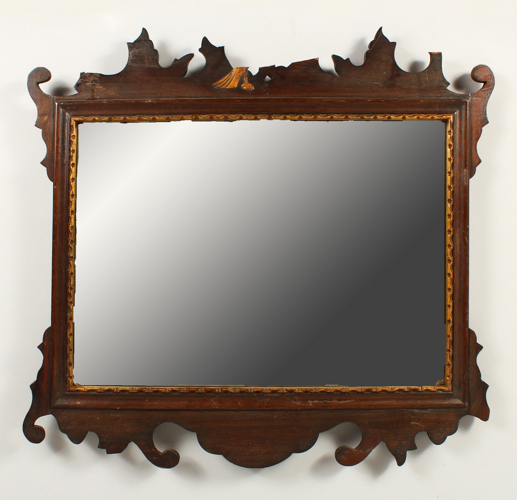 A GEORGIAN STYLE MAHOGANY FRETWORK FRAMED MIRROR. 54cms high x 56cms wide.