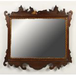 A GEORGIAN STYLE MAHOGANY FRETWORK FRAMED MIRROR. 54cms high x 56cms wide.