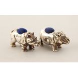 A SILVER RHINO AND HIPPO PIN CUSHION.