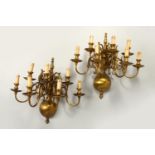 A PAIR OF DUTCH STYLE BRASS SEVEN BRANCH WALL APPLIQUES. 54cms high.
