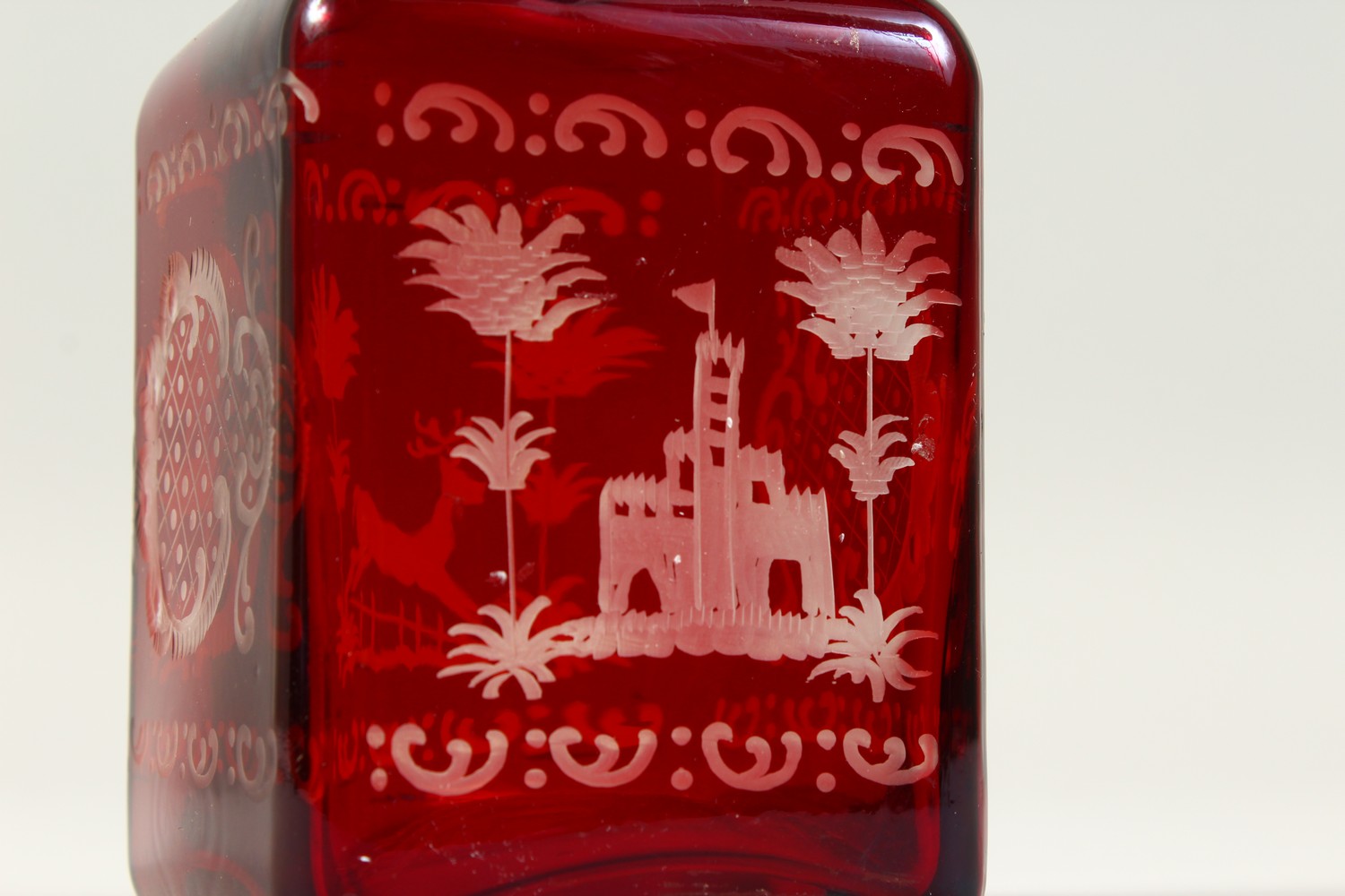 A BOHEMIAN SQUARE SHAPE RUBY GLASS DECANTER, engraved with a castle and a deer. 19cms high. - Image 2 of 9