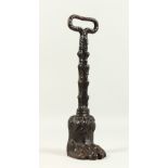 A 19TH CENTURY CAST IRON PAW SHAPED DOOR PORTER. 35cms high.