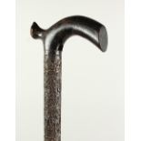 A CEYLONESE CARVED EBONY WALKING CANE. 95cms long.