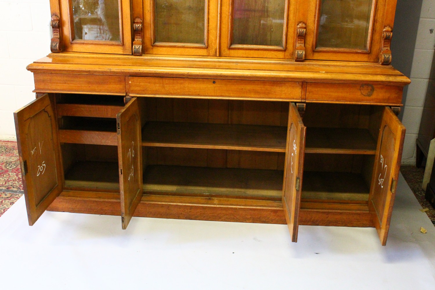 A VICTORIAN OAK LIBRARY BOOKCASE, with a moulded cornice above four glazed doors enclosing - Image 17 of 17