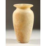 AN ALABASTER URN. possibly Egyptian. 20cms high.
