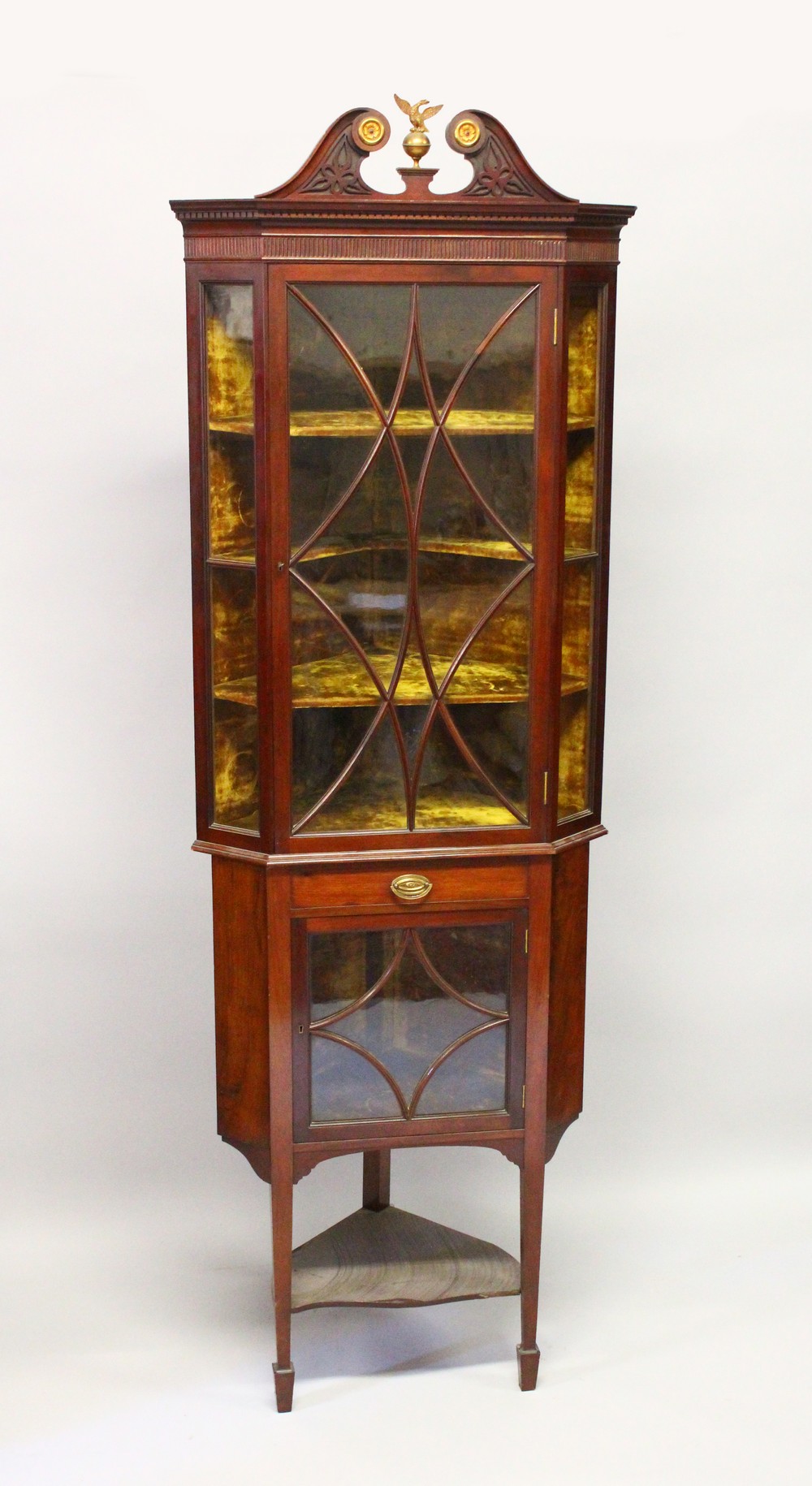 A GEORGE III DESIGN MAHOGANY CORNER CABINET, on associated stand, with pierced swan neck cresting,