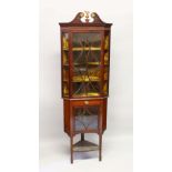 A GEORGE III DESIGN MAHOGANY CORNER CABINET, on associated stand, with pierced swan neck cresting,
