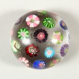 A CLICHY SCATTERED CANE PAPERWEIGHT. 5.5cms diameter.