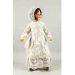 ALT BECK & GOTTSCHALK A BISQUE HEADED BABY DOLL, with long hair and bonnet, articulated body,