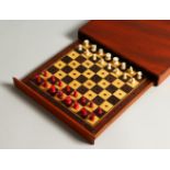 A MAHOGANY CASED TRAVELLING CHESS SET. 20cms wide.
