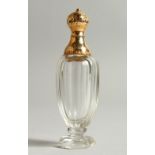 A GOLD TOP CUT GLASS SCENT BOTTLE. 10.5cms high.