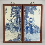 A PAIR OF BLUE AND WHITE PORCELAIN PLAQUES, figures by a tree, in wood frames. 88cms high x 45cms