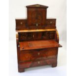 A 19TH CENTURY CONTINENTAL MAHOGANY CYLINDER BUREAU CABINET, the upper section with a central