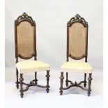 A PAIR OF DUTCH STYLE WALNUT HIGH BACK CHAIR, LATE 19TH CENTURY, with carved cresting rails, cane